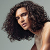 image of a man with long, wavy brunette hair