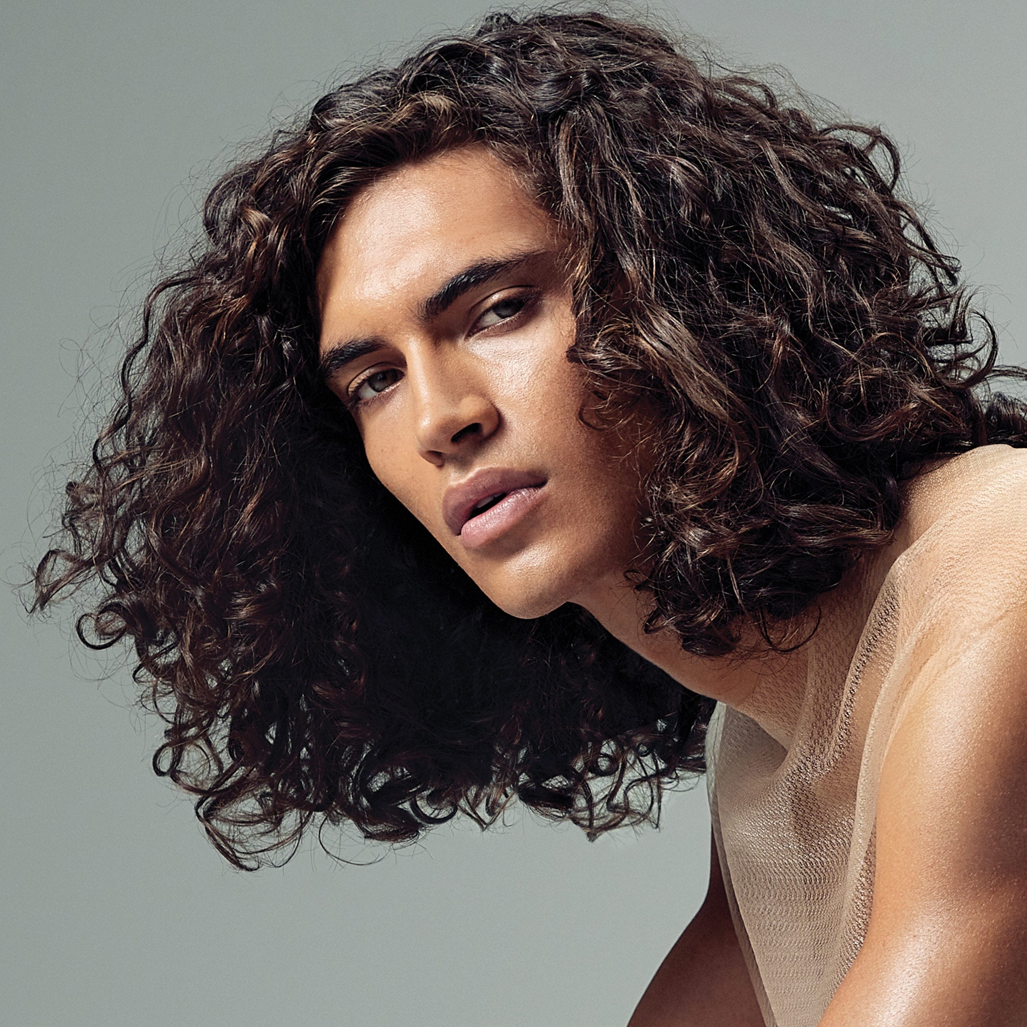image of a man with long, wavy brunette hair