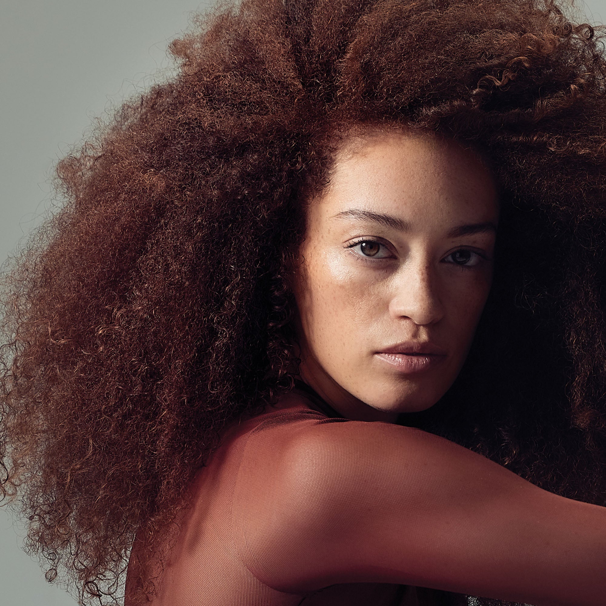 image of a woman with voluminous, coily, brunette hair